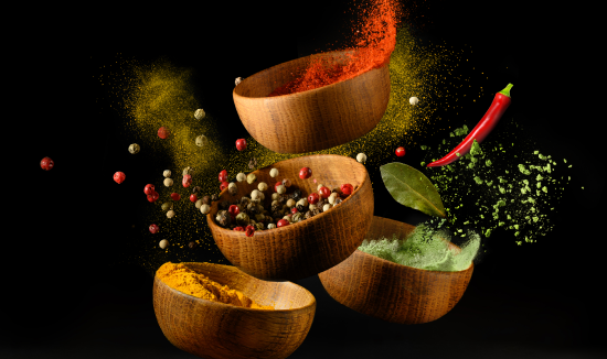 spices-seasonings-powder-splash-explosion-black-background 1